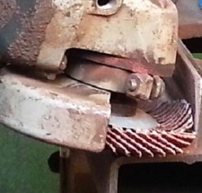 Close up of flap disc being used against steel beam